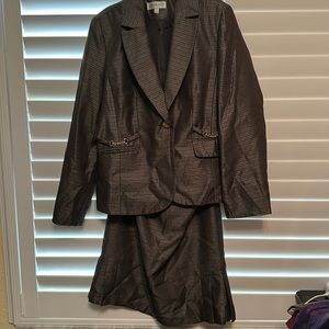 Suit with gold accents, skirt has flared bottom